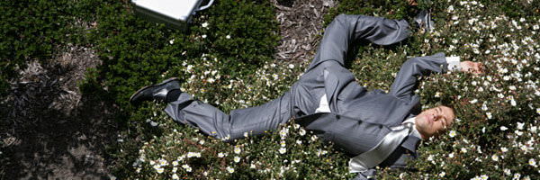  Young businessman sprawled out on ground
